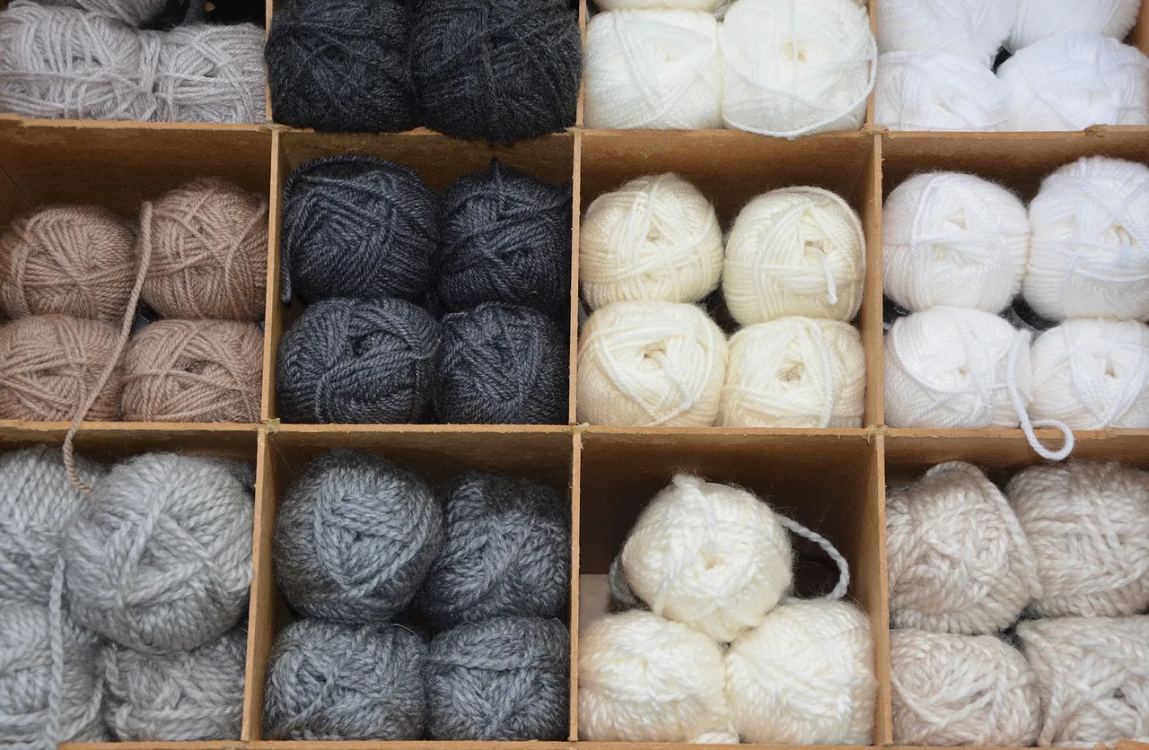balls of wool, colors, grey, white, ecru, shades, brown, locker, storage. Which moth-control habits actually protect a small sweater mending setup?