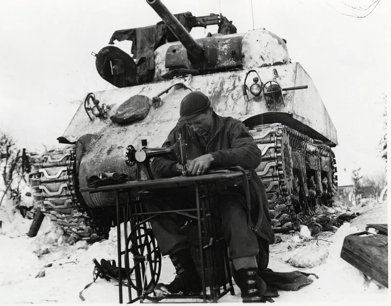 This is a photograph of Sgt. William Phelps of San Antonio, Texas, a tanker of the 42nd Tank Battalion, mending his combat clothes in Steinbach, Belgium. He uses a sewing machine i. Which new services can a small repair studio add without new equipment?