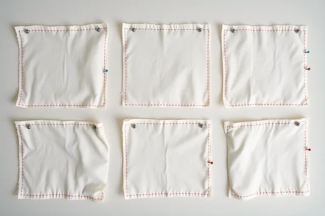 Six fabric squares with pinned four-inch reference lines, three treated, three untreated. 4 things the garment repair case studies teach