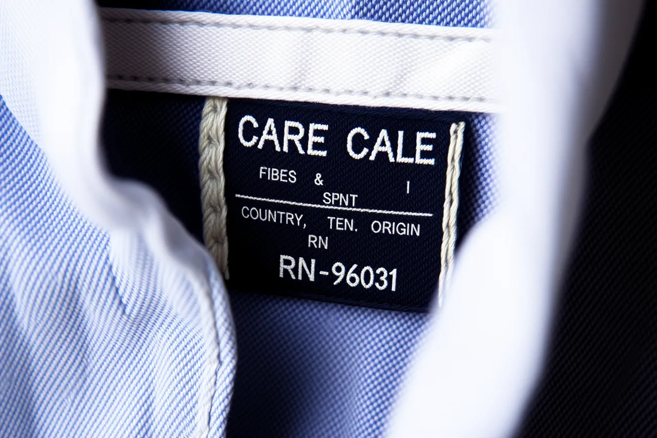 Close-up of a garment care label showing fiber content and RN number (4 things to weigh up on clothing repair projects)